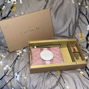 Boxed coach wristlet w/ charms included